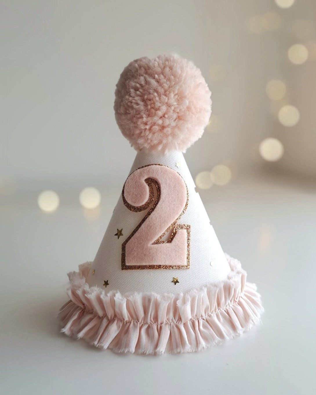 Vintage-inspired pink birthday hat and cape set, perfect for keepsake gifting