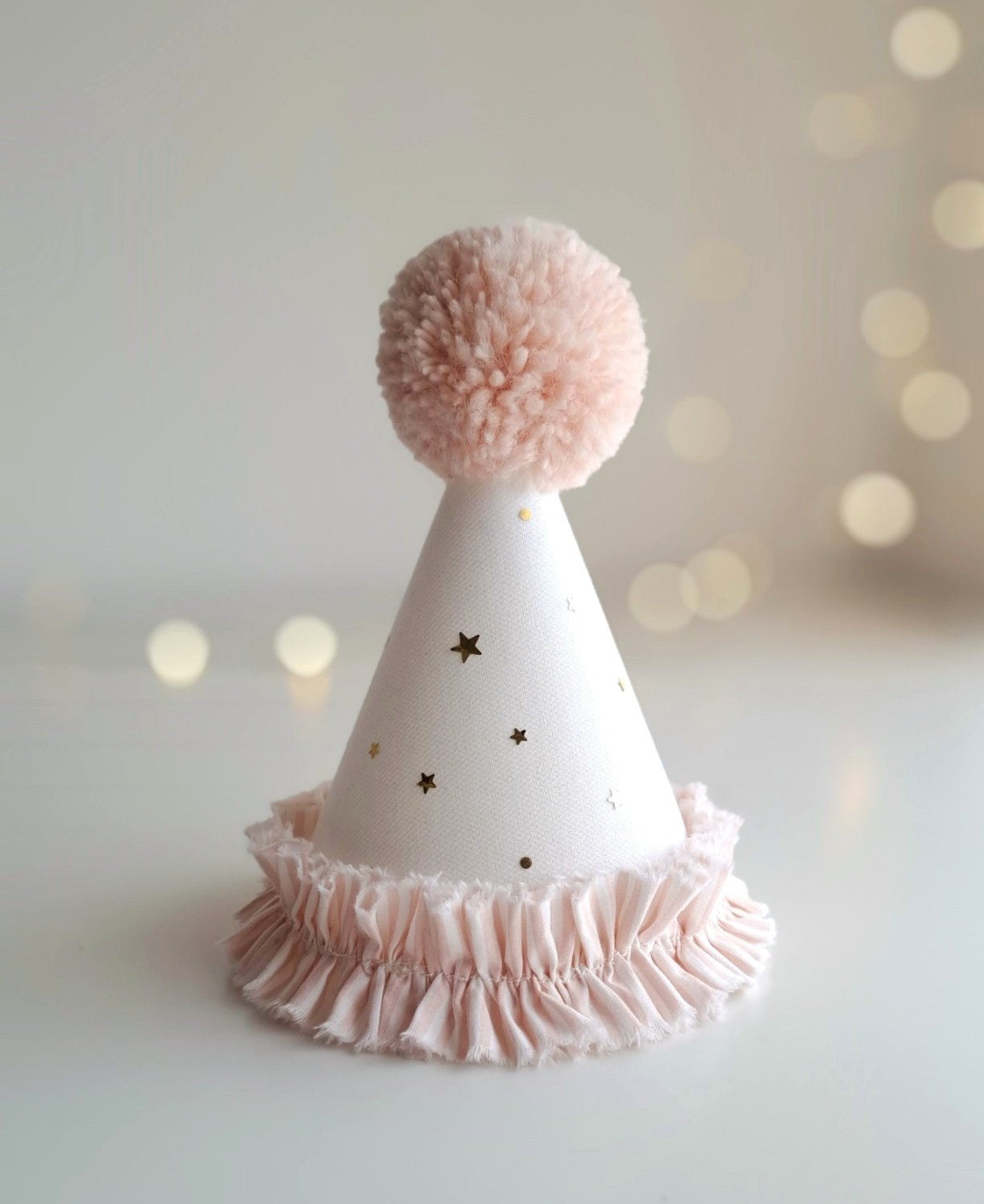 Pink stripe handmade birthday hat with gold star tulle and plush pink pompom shown without felt number