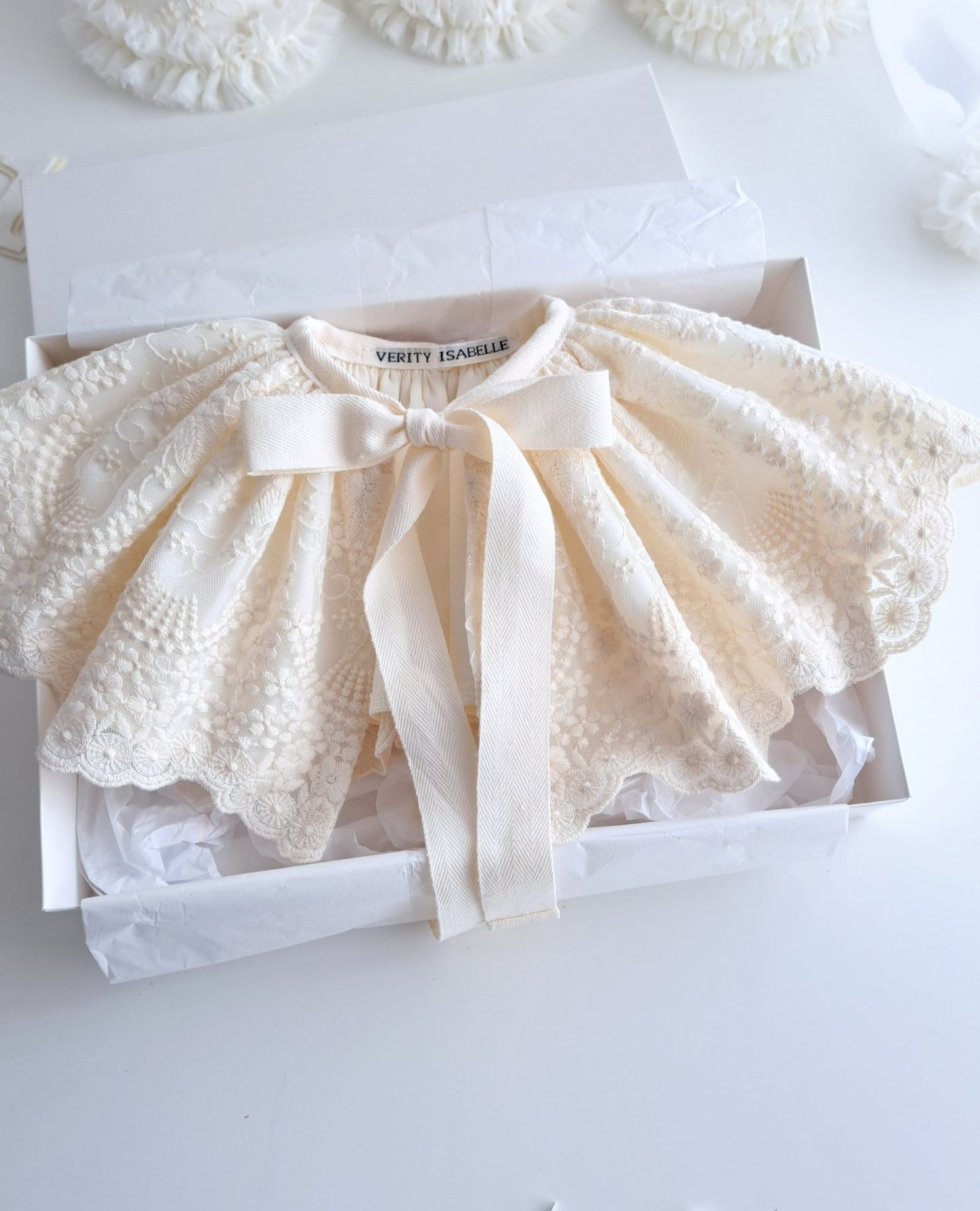 Flat lay of Lucine cape – handmade children’s cape, cotton overaid with lace.