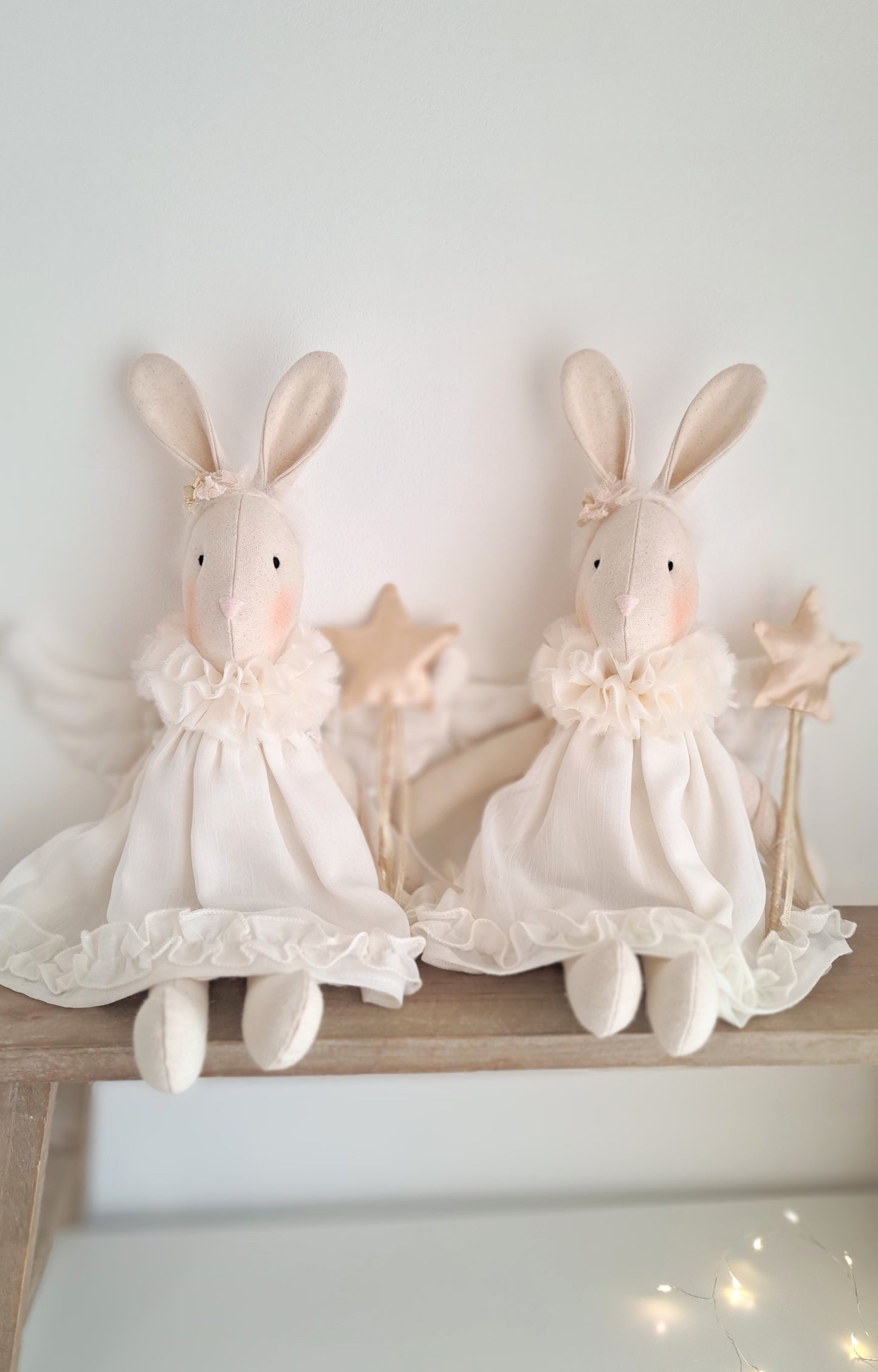 Two Angel Veronica Bunny dolls styled together on a shelf, handmade Christmas keepsake bunnies in ivory chiffon dresses