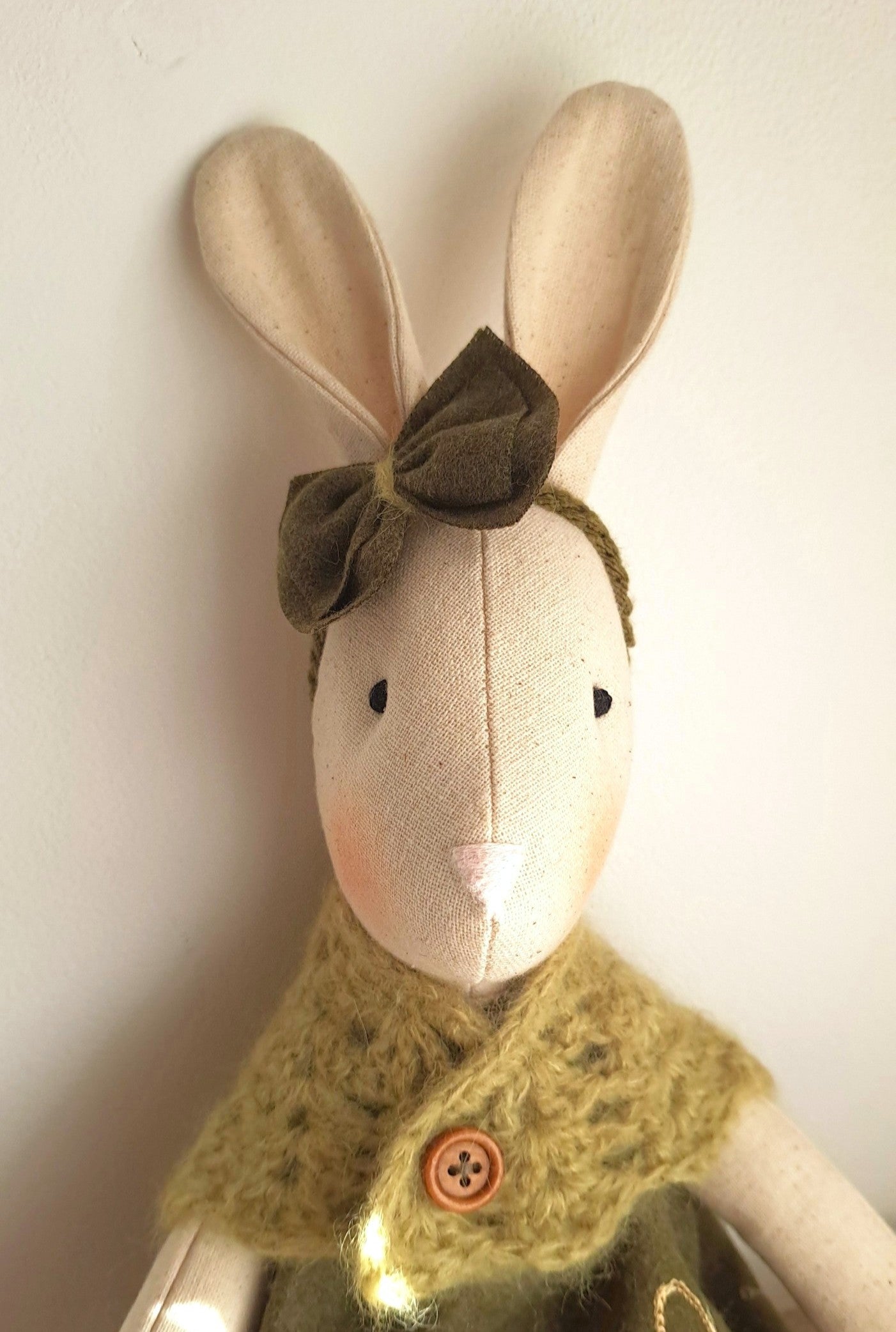 Heirloom fabric bunny toy with long ears and green dress
