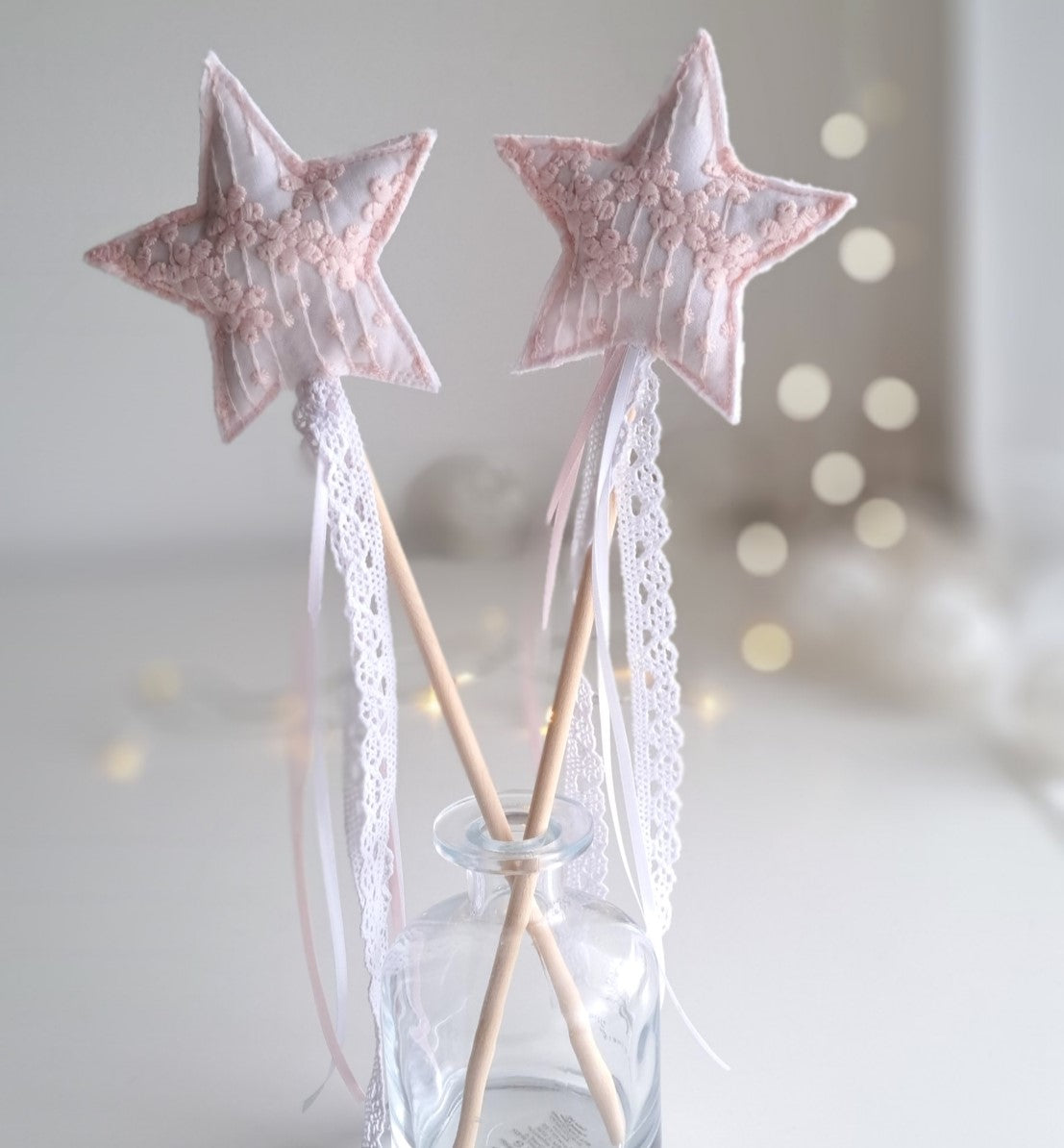 Handmade pink princess star wands with soft embroidered fabric stars, wooden handles, lace streamers and pale ribbon ties.