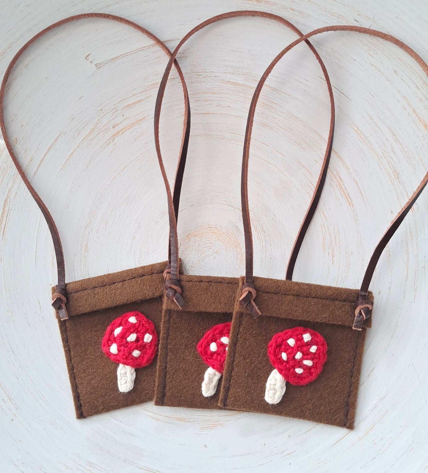 Miniature felt satchel with red toadstool mushroom design