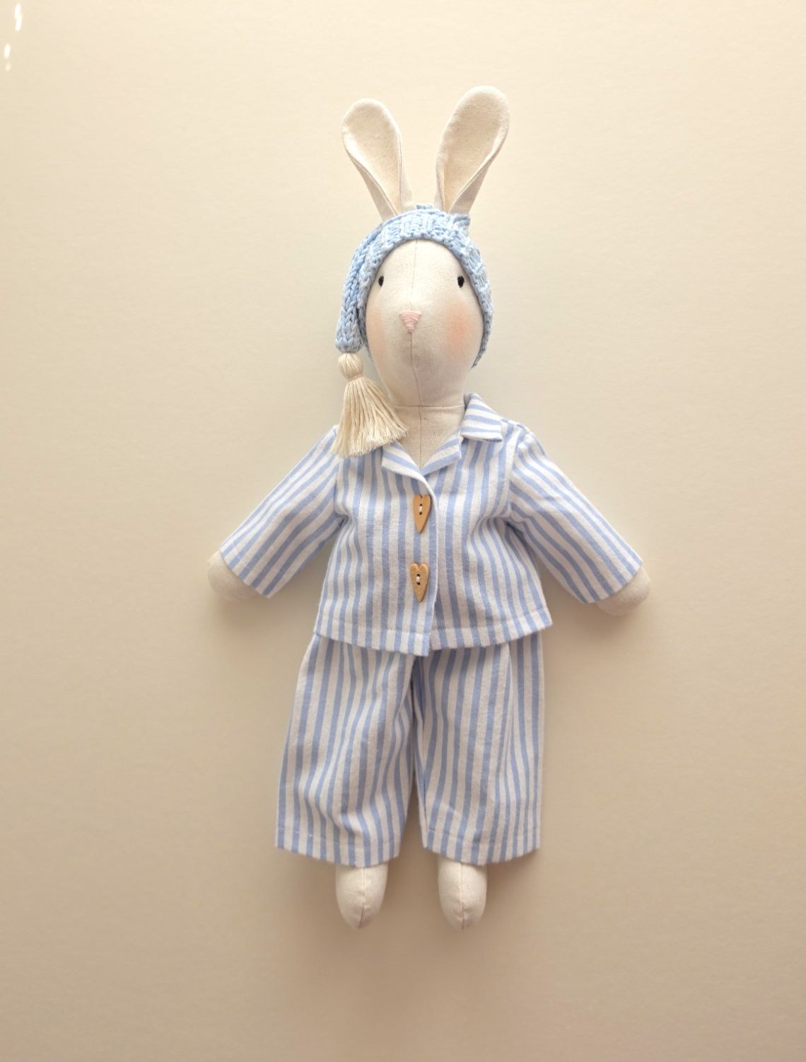 Handmade linen Gerald Bunny wearing blue striped pyjamas and a hand-knitted blue sleepy hat.