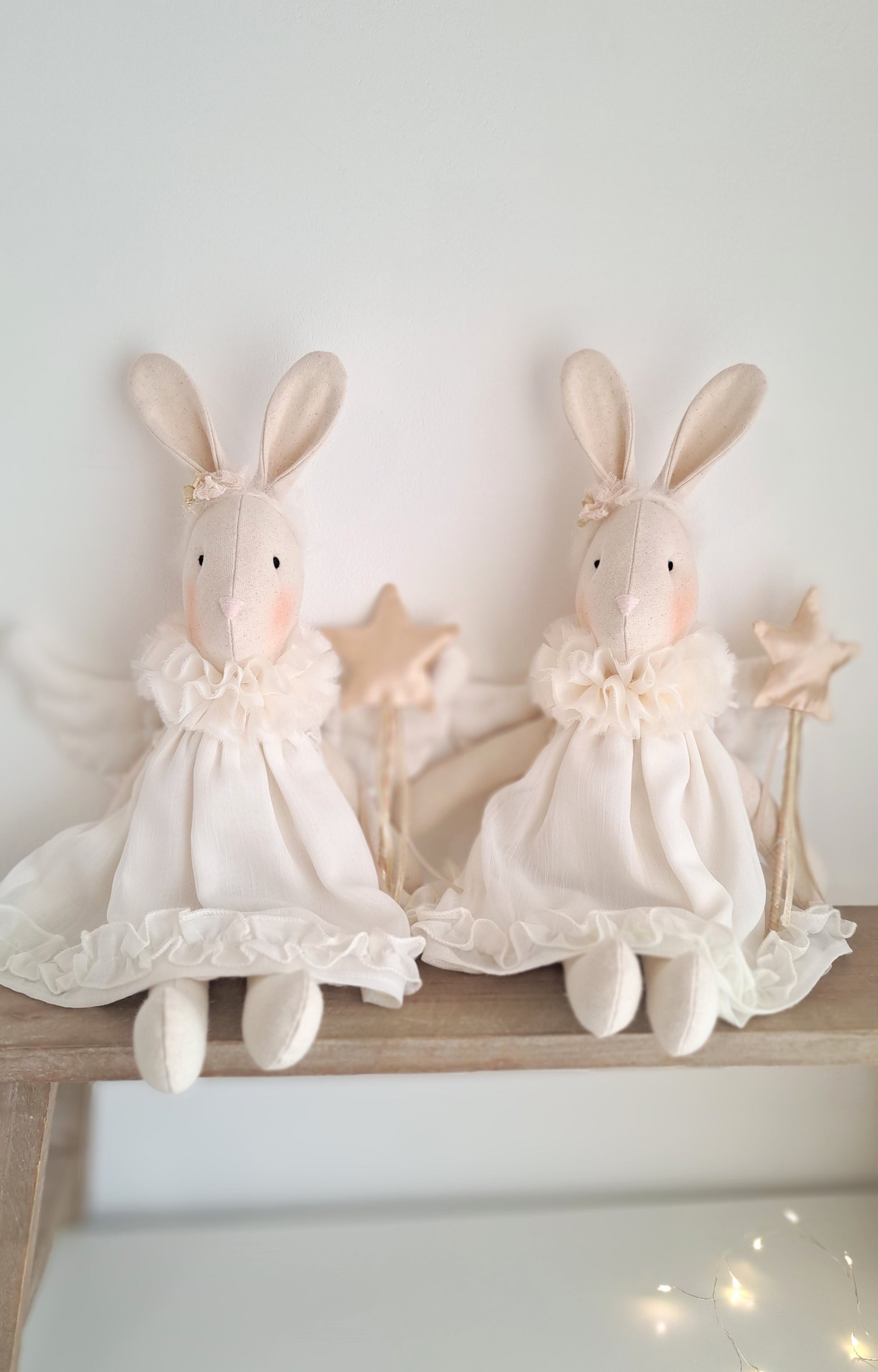 Two Angel Veronica Bunny dolls styled together on a shelf, handmade Christmas keepsake bunnies in ivory chiffon dresses