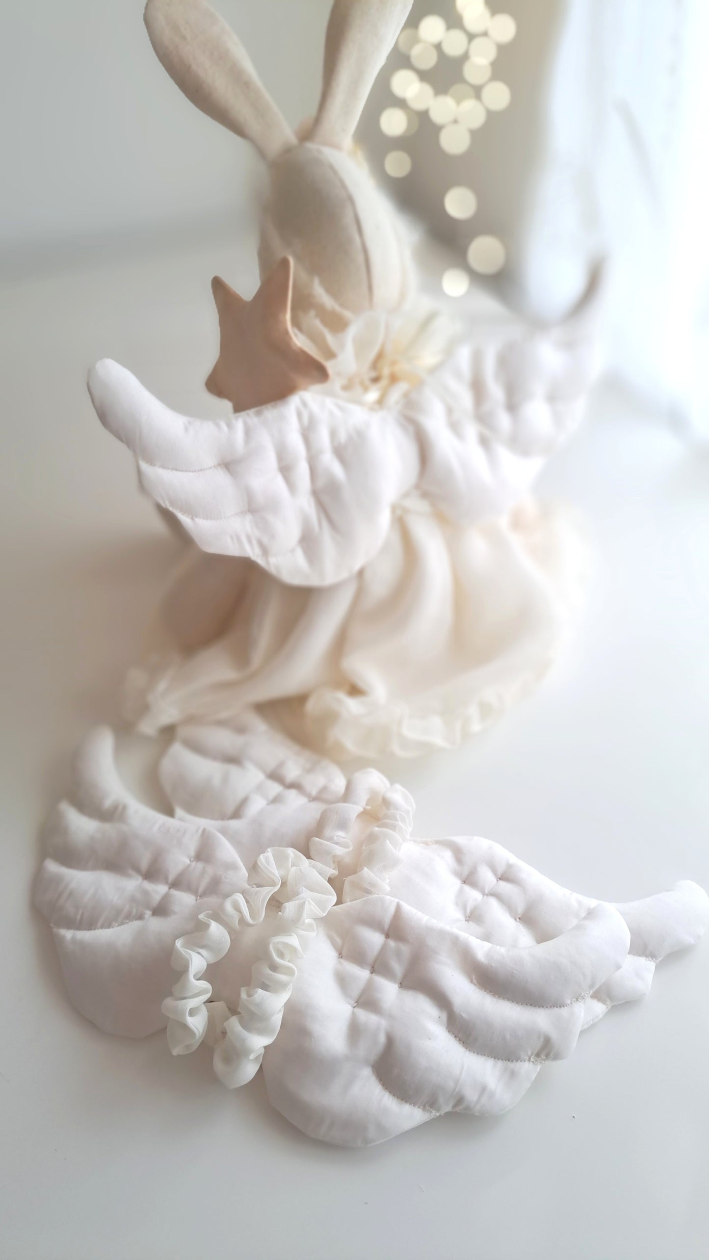 Back view of Angel Veronica Bunny showing hand-quilted satin angel wings tied with ribbon, handmade Christmas keepsake bunny