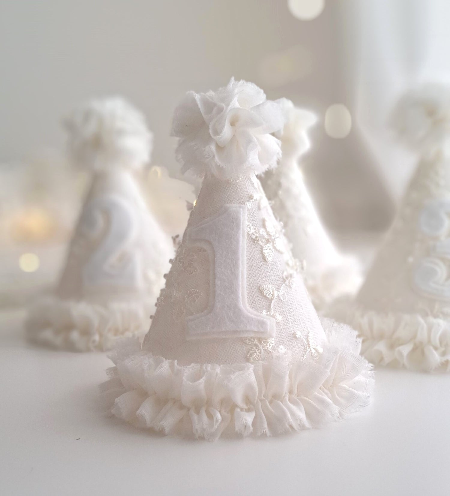 Collection of Celeste beaded lace party hats in ivory, handmade with delicate lace, beading, ruffled trim and tulle pom tops