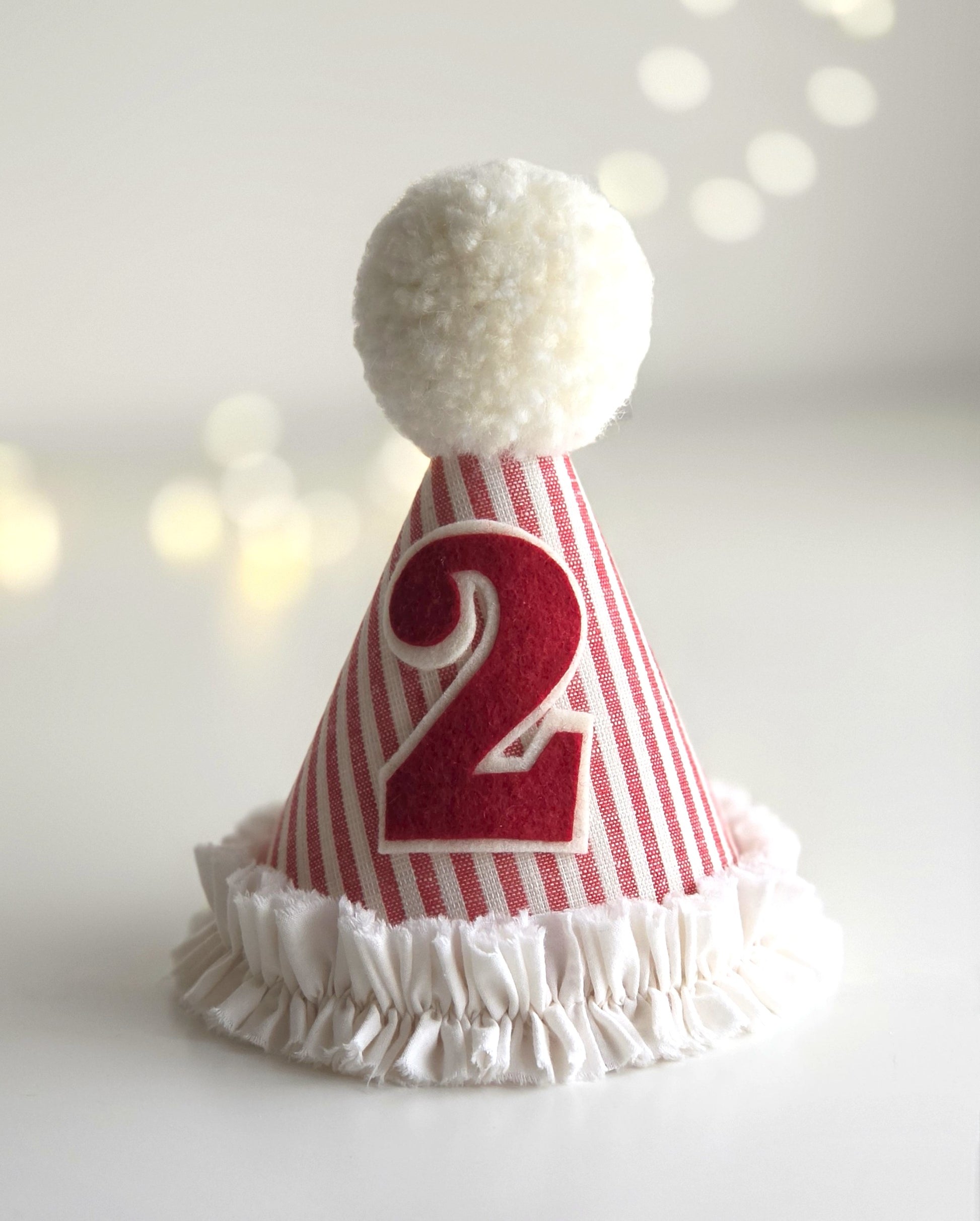 Handmade red striped birthday party hat with number 2 and gathered ruffle edge for girls