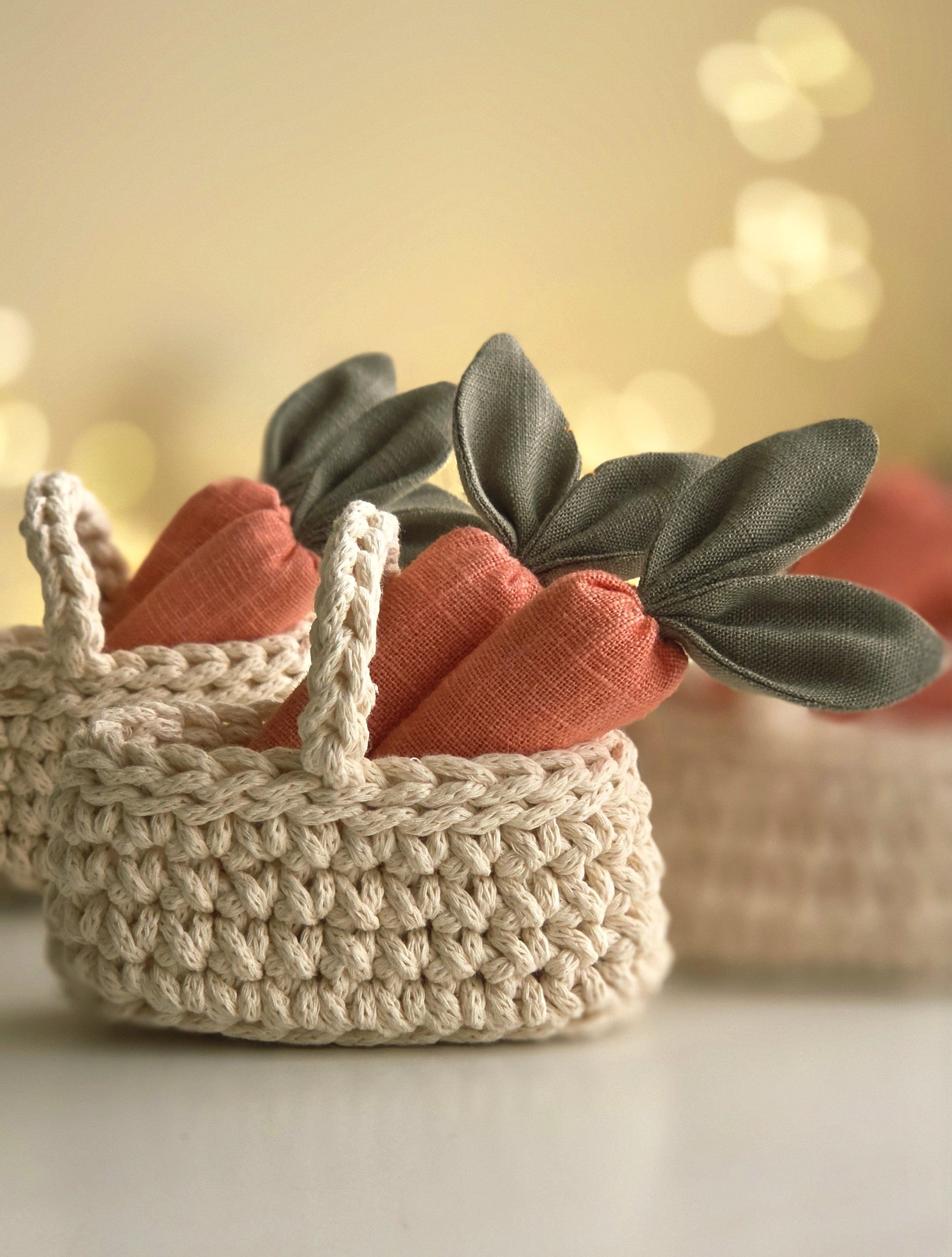 Hand-crocheted basket filled with soft linen carrots, spring toy accessory in warm natural tones