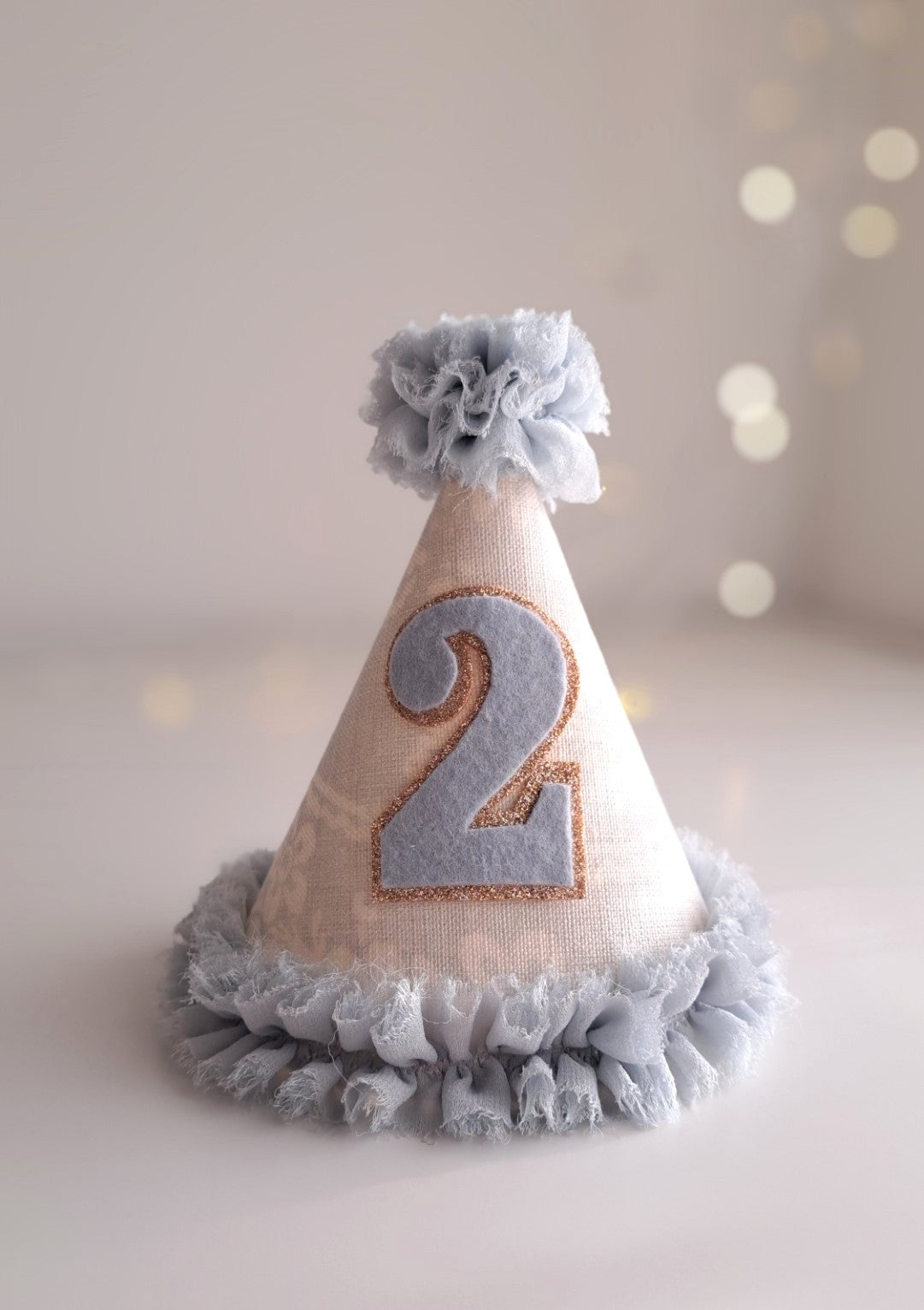 Pale blue number 2 birthday party hat with linen cone, blue ruffle trim and felt number, handmade by Verity Isabelle.