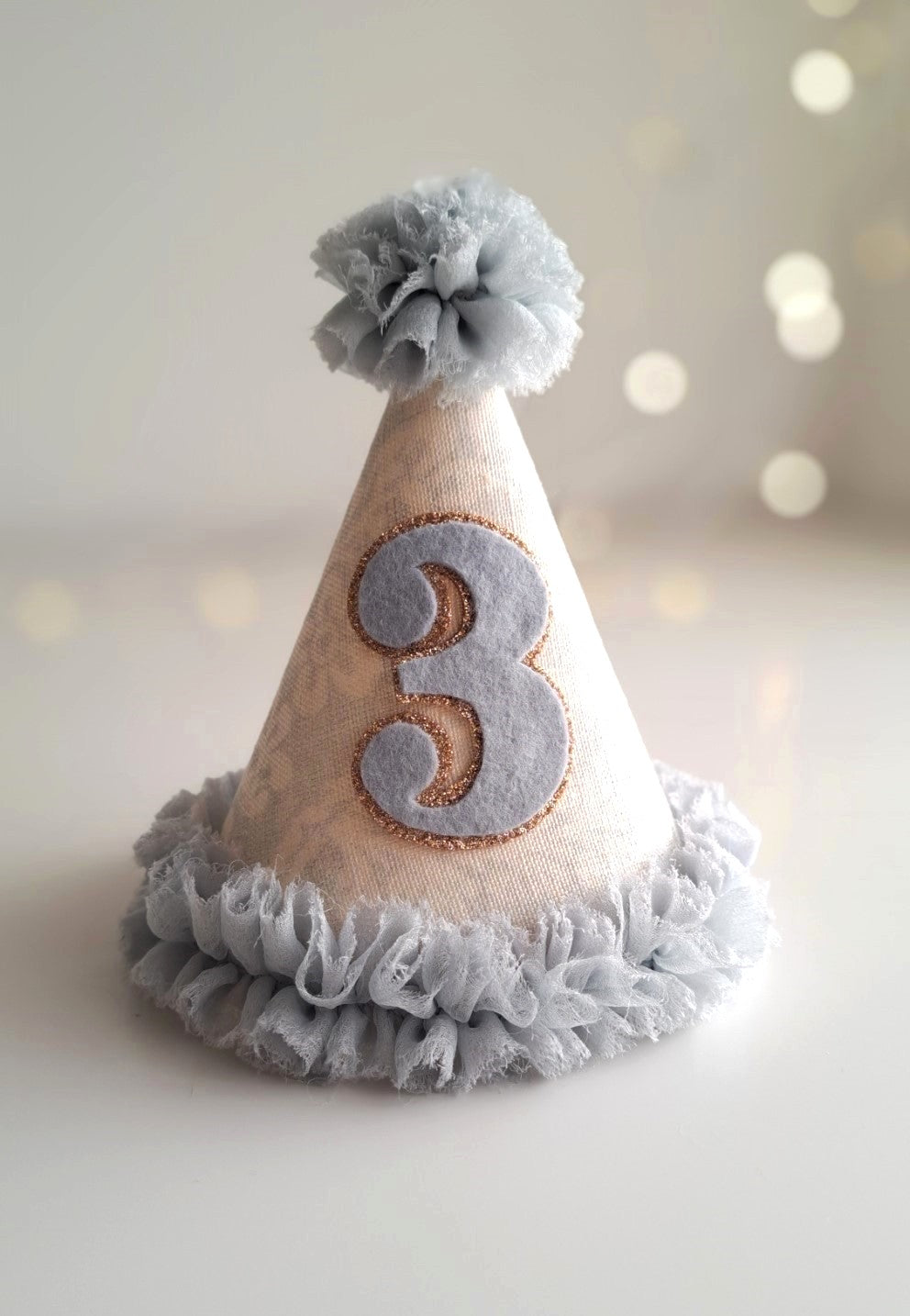 Pale blue number 3 birthday party hat with linen cone, blue ruffle trim and felt number, handmade by Verity Isabelle.
