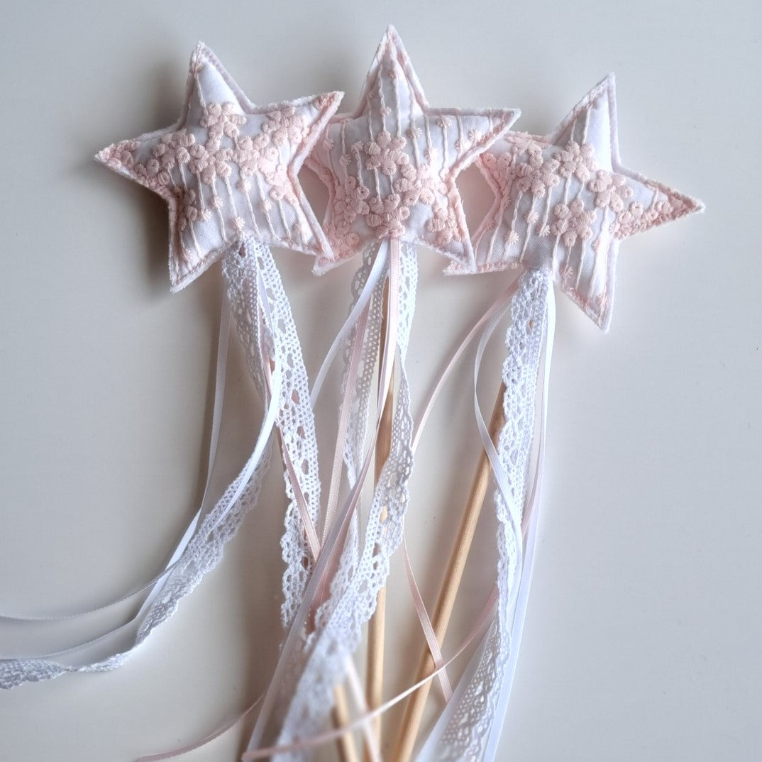 Set of handmade pink princess star party wands with embroidered floral fabric, wooden handles, lace and ribbon streamers.