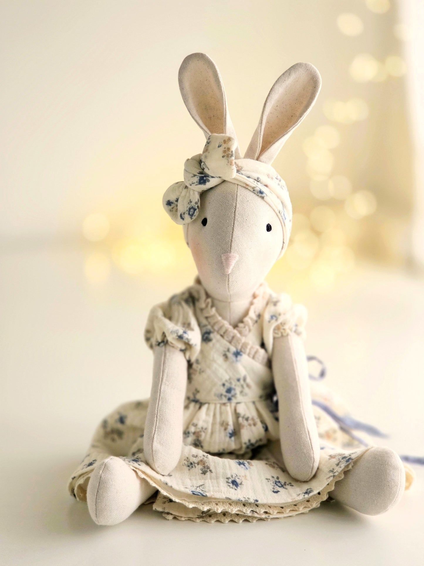 Spring Veronica Bunny handmade soft toy wearing a blue floral gauze dress and matching headband