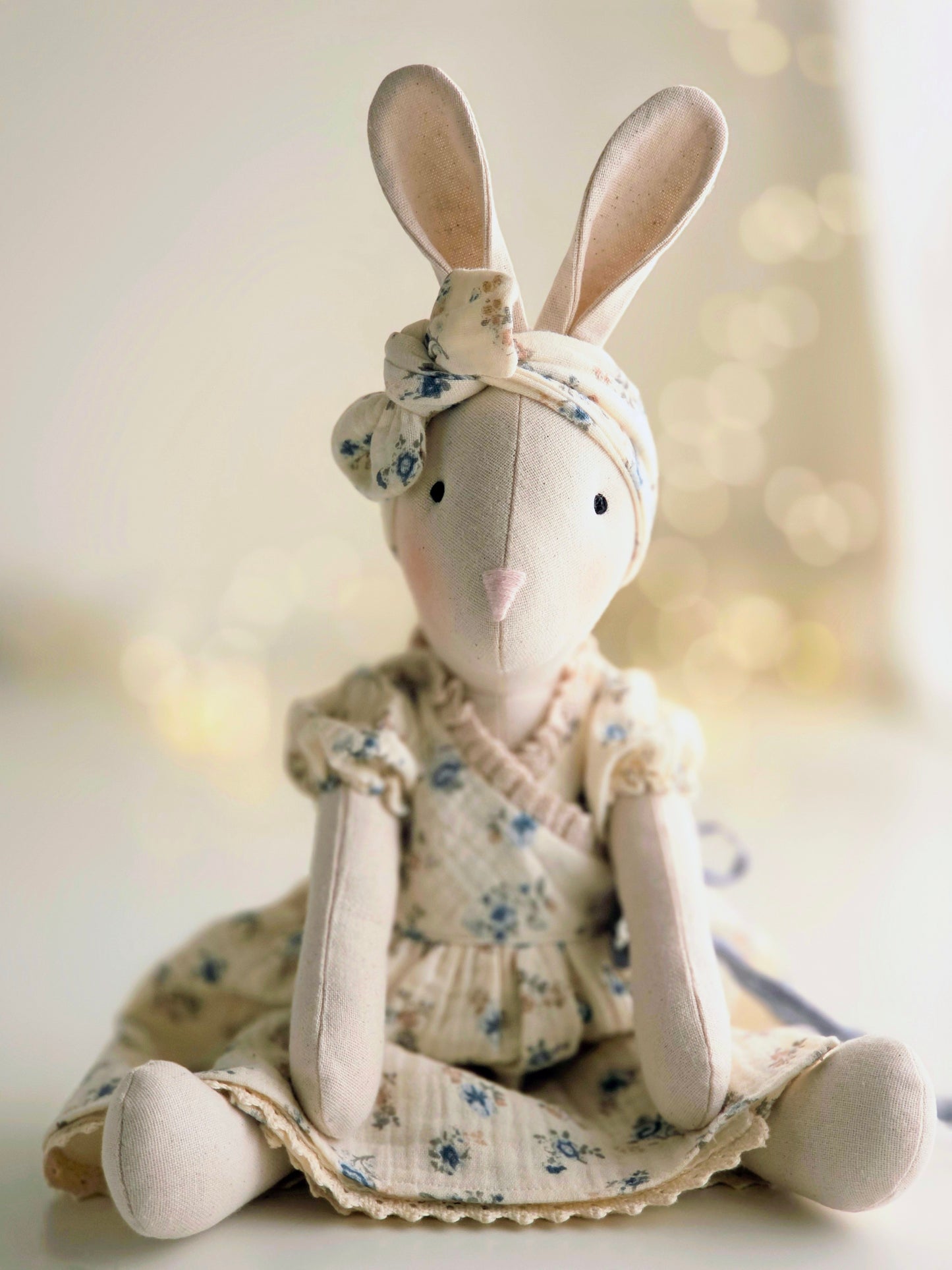 Spring Veronica Bunny handmade soft toy wearing a blue floral gauze dress and matching headband