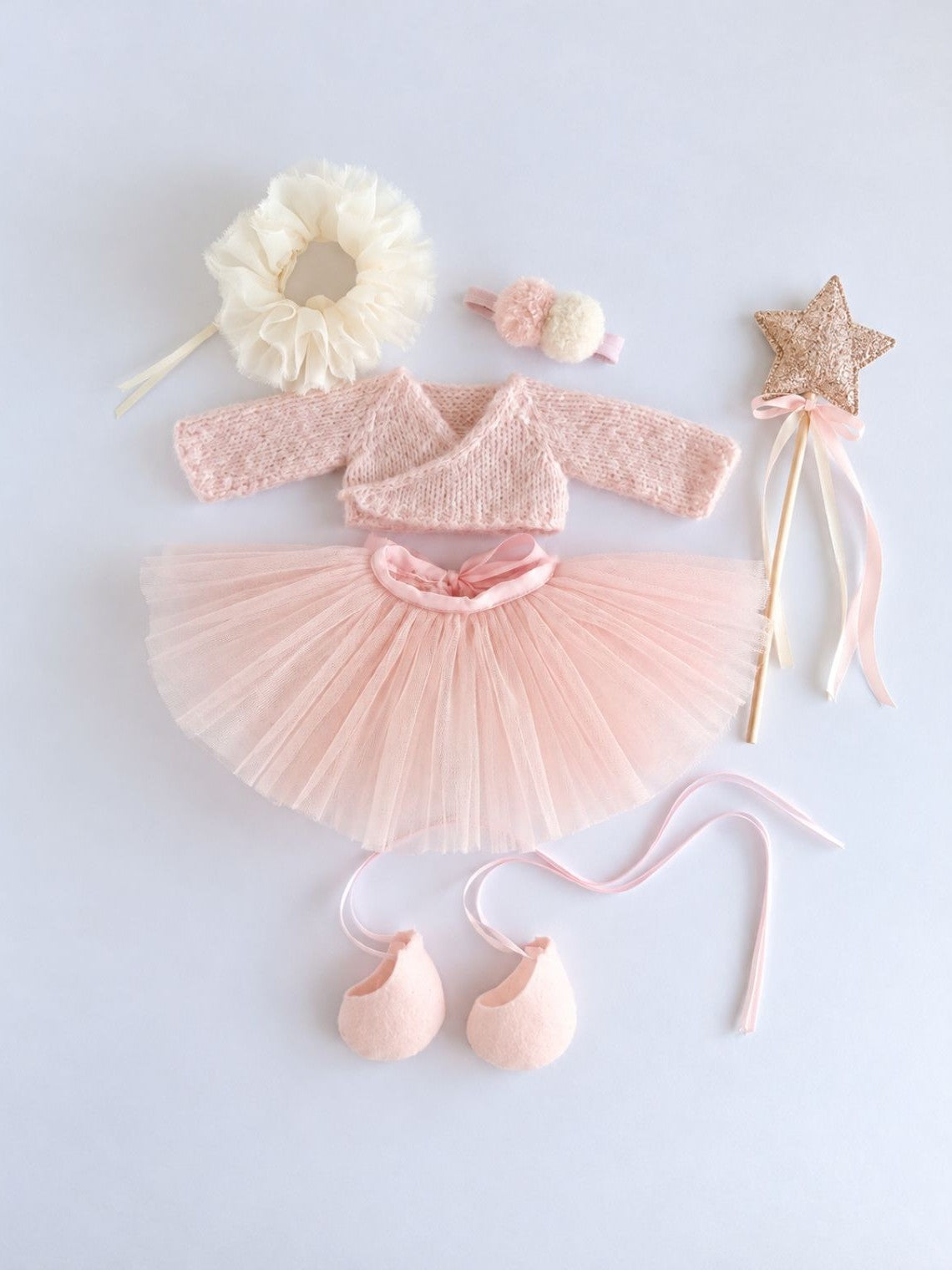 Ballerina Bunny outfit flat lay with tulle tutu, alpaca cardigan, ruffle collar, headband, wand and ballet shoes.