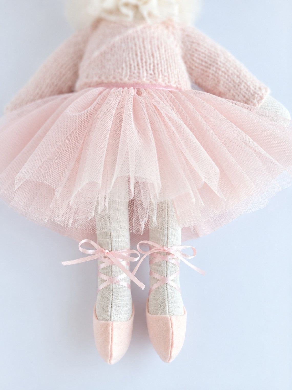 Close-up of the pink tulle tutu and ribbon-laced ballet shoes on handmade Verity Ballerina Bunny.