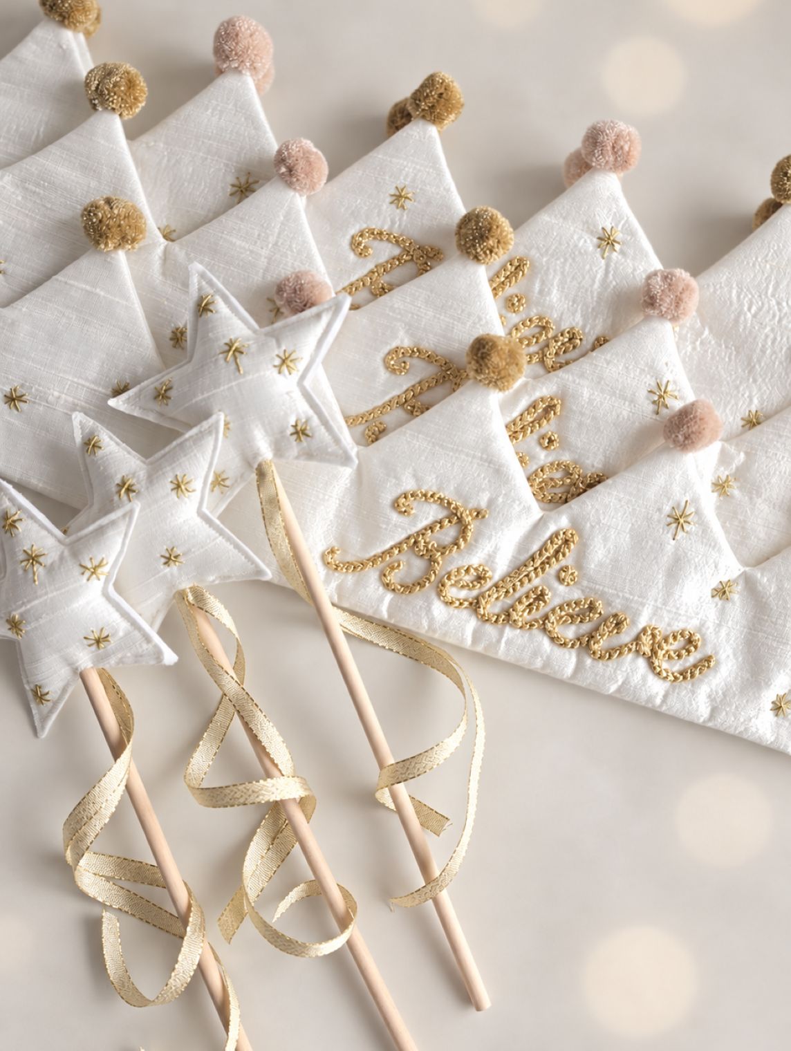 Believe silk Christmas crowns and star wands with gold embroidery, ribbon and handmade festive details.