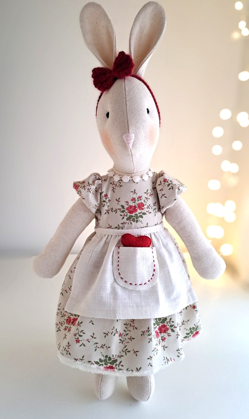 Veronica Bunny Valentine’s edition, handmade heirloom doll wearing a vintage rose floral dress, linen apron and crocheted red headband